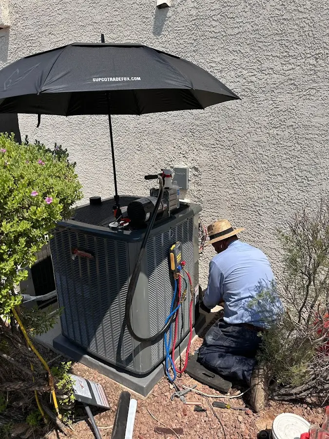 HVAC technician performing outdoor AC maintenance in Hurst